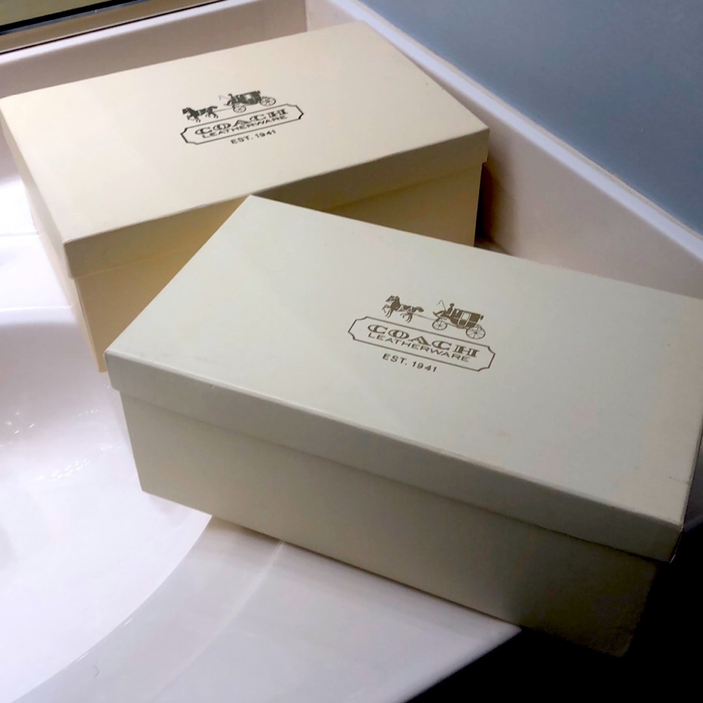 Two pairs of women coach can you shoes, black, and brown.